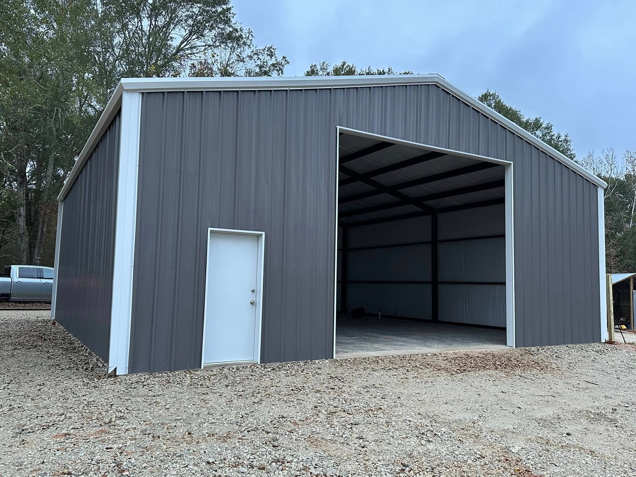 Metal building with large bay door — Premier Steel & Construction