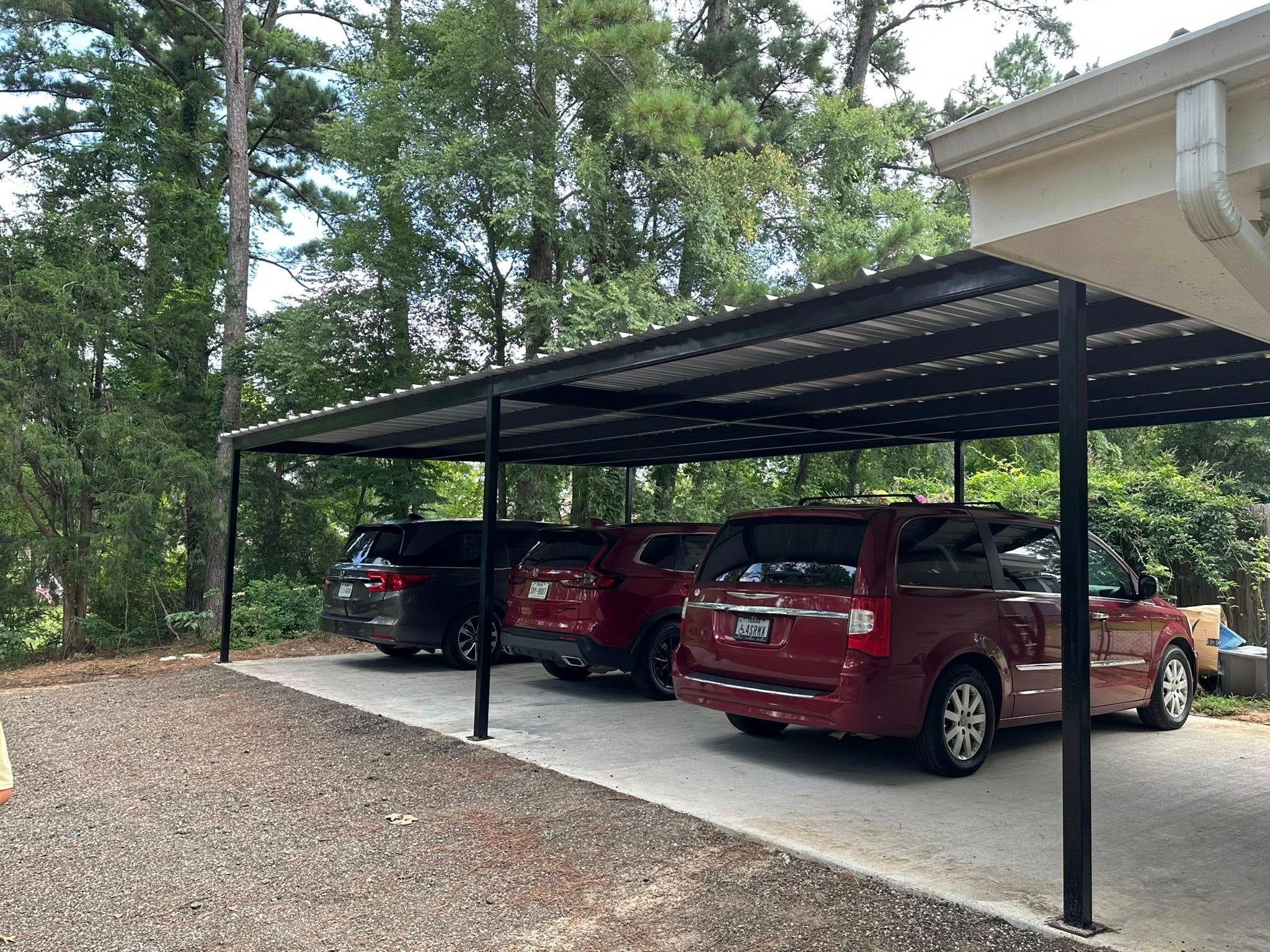 Steel carport with vehicles — Premier Steel & Construction
